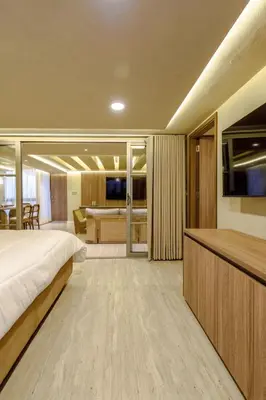 a bedroom with a bed and a living room at Suites la iglesia in Cartagena de Indias