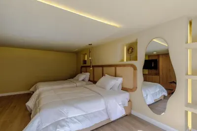 a bedroom with two beds and a mirror at Suites la iglesia in Cartagena de Indias