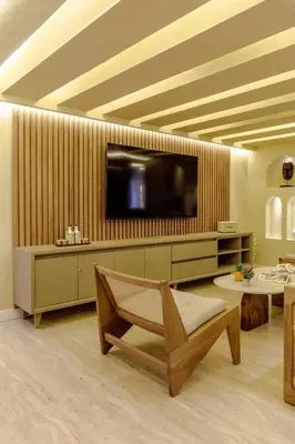 a living room with a flat screen tv and a chair at Suites la iglesia in Cartagena de Indias