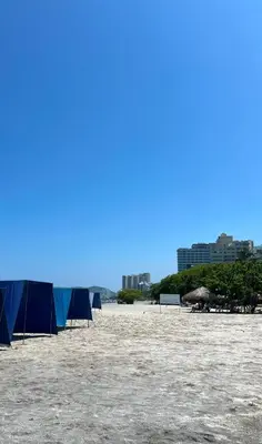 a group of blue tents on a sandy beach at Apartamento en Bello Horizonte, Santa Marta in Santa Marta
