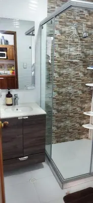 a bathroom with a glass shower and a sink at Apartamento en Bello Horizonte, Santa Marta in Santa Marta
