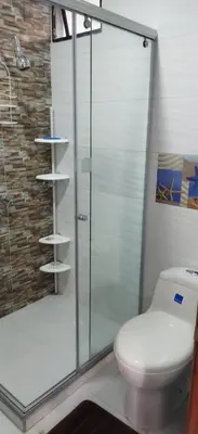 a bathroom with a toilet and a glass shower at Apartamento en Bello Horizonte, Santa Marta in Santa Marta