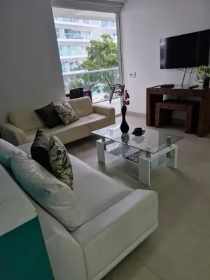 a living room with a white couch and a table at Apartamento con vista al Mar Cartagena Morros 3 in Cartagena de Indias