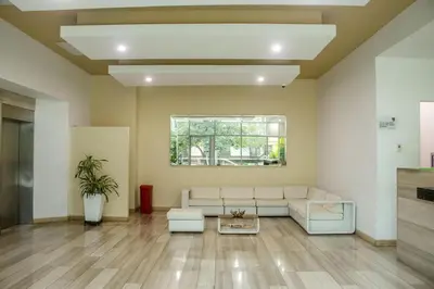a living room with a white couch and a window at Apartment Hilton Garden Inn Building in Barranquilla