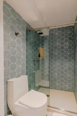 a bathroom with a toilet and a glass shower at Lux Beach House, Aldaba Selection in Cartagena de Indias