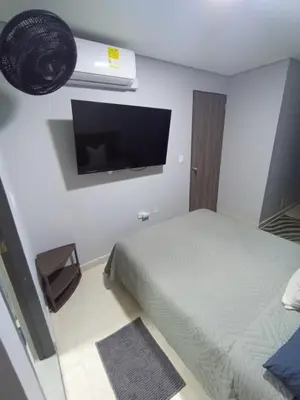 a bedroom with a bed and a flat screen tv at Amaneceres de ensueño en Cartagena in Cartagena de Indias