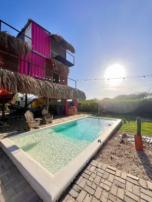 a swimming pool in front of a house at Mojarra Beach Casa privada Vista al mar in Salina de Rey