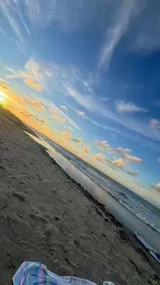 a beach with the ocean and a cloudy sky at Mojarra Beach Casa privada Vista al mar in Salina de Rey