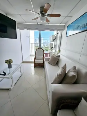 a living room with a couch and a ceiling fan at Vacation Home with water views in every room! in Cartagena de Indias