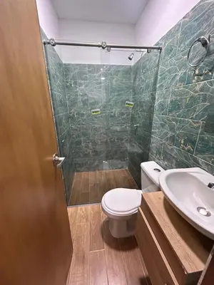 a bathroom with a shower and a toilet and a sink at Apartamento Villa Mary C-202 in Coveñas