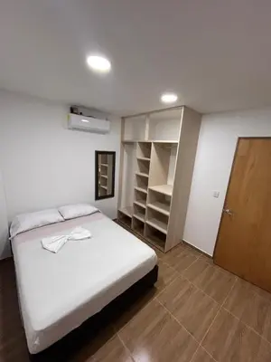 a bedroom with a white bed and a closet at Apartamento Villa Mary C-202 in Coveñas