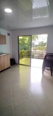 an empty room with a room with a large glass door at Casa de playa moñitos in Moñitos
