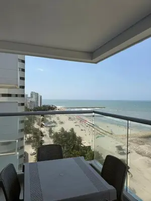 a balcony with a table and a view of the beach at Palmeto Beach 04 - 1 alcoba in Cartagena de Indias