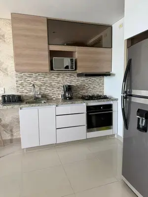 a kitchen with white cabinets and stainless steel appliances at Palmeto Beach 04 - 1 alcoba in Cartagena de Indias