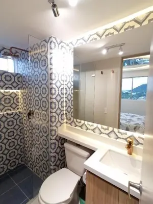 a bathroom with a toilet and a sink and a mirror at Apartamento Rosedale in Cartagena de Indias