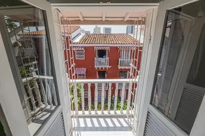 a view from the balcony of a red building at Amplio apartamento familiar de 2 habitaciones dentro de la Ciudad Amurallada - AC, Wifi rapido y Agua caliente in Cartagena de Indias