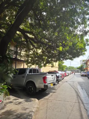 a truck parked on the side of a street with parked cars at Amplio apartamento familiar de 2 habitaciones dentro de la Ciudad Amurallada - AC, Wifi rapido y Agua caliente in Cartagena de Indias