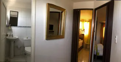 a bathroom with a toilet and a sink and a mirror at El taller del artista I in Cartagena de Indias