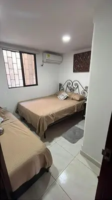 a room with two beds and two windows at Casa Étoile ideal location Ctg in Cartagena de Indias