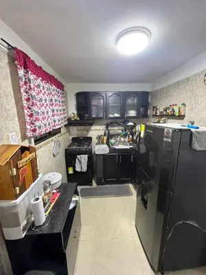 a kitchen with black cabinets and a refrigerator at Casa Étoile ideal location Ctg in Cartagena de Indias