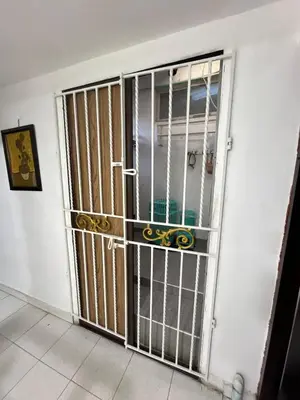 a door with bars on it in a room at Casa Étoile ideal location Ctg in Cartagena de Indias