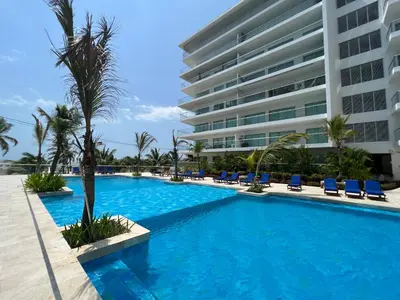 a swimming pool in front of a building at Espectacular apto frente al Mar! in Cartagena de Indias