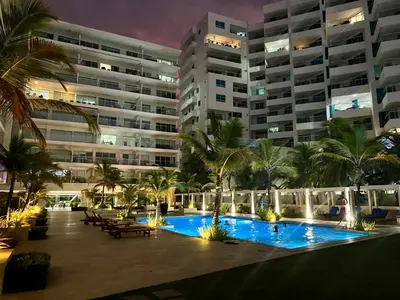 a large building with a swimming pool at night at Espectacular apto frente al Mar! in Cartagena de Indias