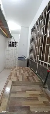 a room with a wall of windows and a wooden floor at Apartamento #1 in Puerto Colombia