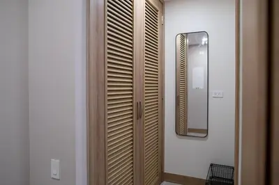 a wooden closet in a room with a mirror at Loft con salida al mar en Cartagena in Cartagena de Indias