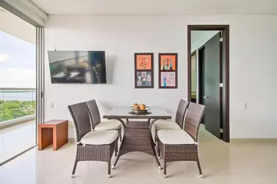 a dining room with a table and chairs at Beach 2-bedroom apartment in Cartagena de Indias