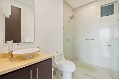 a bathroom with a toilet and a sink and a shower at Beach 2-bedroom apartment in Cartagena de Indias