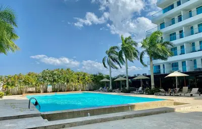 a swimming pool in front of a hotel at Beach 2-bedroom apartment in Cartagena de Indias