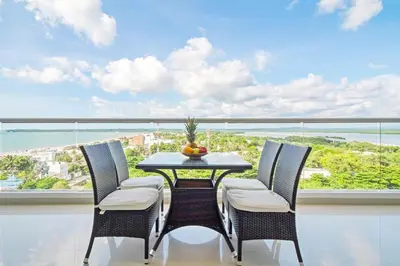 a dining room with a table and chairs in front of a window at Beach 2-bedroom apartment in Cartagena de Indias
