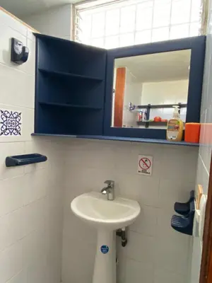 a bathroom with a sink and a mirror at Playa Los alcatraces in Santa Marta