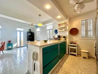 a kitchen with a green island in a room at by Calamari Homes - El Porvenir 401 walled city in Cartagena de Indias