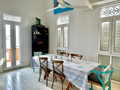 a dining room with a white table and chairs at by Calamari Homes - El Porvenir 401 walled city in Cartagena de Indias