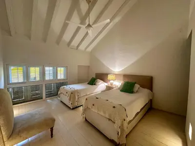 a bedroom with two beds and a ceiling fan at by Calamari Homes - El Porvenir 401 walled city in Cartagena de Indias