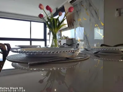 a table with plates and a vase of flowers on it at Murano centro 1 - 25 Floor byIMZ in Cartagena de Indias