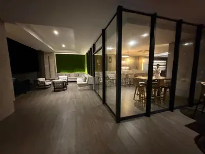 a room with glass doors and a room with tables and chairs at Murano centro 1 - 25 Floor byIMZ in Cartagena de Indias