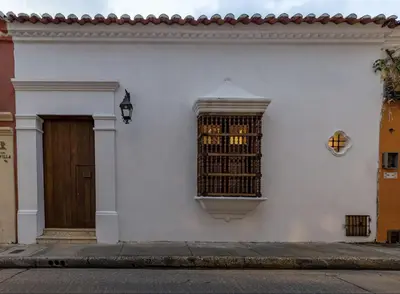 a white building with a window and a door at Colonial House with Pool in Cartagena de Indias