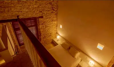 a room with a staircase with a couch and a brick wall at Colonial House with Pool in Cartagena de Indias