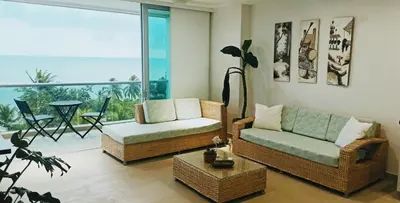 a living room with two couches and a balcony at Edificio Mares de Coveñas apto frente al Mares de coveñas in Coveñas