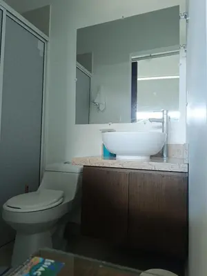 a bathroom with a sink and a toilet and a mirror at Edificio Mares de Coveñas apto frente al Mares de coveñas in Coveñas