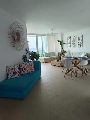 a living room with a blue couch and a table at Edificio Mares de Coveñas apto frente al Mares de coveñas in Coveñas