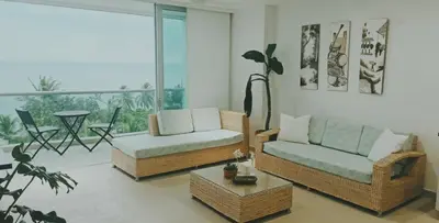 a living room with two couches and a table at Edificio Mares de Coveñas apto frente al Mares de coveñas in Coveñas