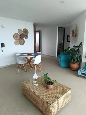 a living room with a table and chairs at Edificio Mares de Coveñas apto frente al Mares de coveñas in Coveñas