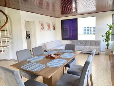 a dining room with a wooden table and chairs at Acogedor Apartamento cerca al Mar in Cartagena de Indias