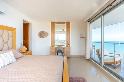 a bedroom with a bed and a view of the ocean at Cartagena Dreams in Cartagena de Indias