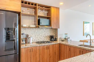 a kitchen with wooden cabinets and a stainless steel refrigerator at Cartagena Dreams in Cartagena de Indias
