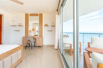 a bedroom with a bed and a view of the ocean at Cartagena Dreams in Cartagena de Indias